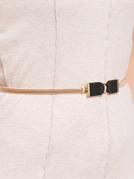 Golden women's Livia belt with a metal bow buckle in the Romano style